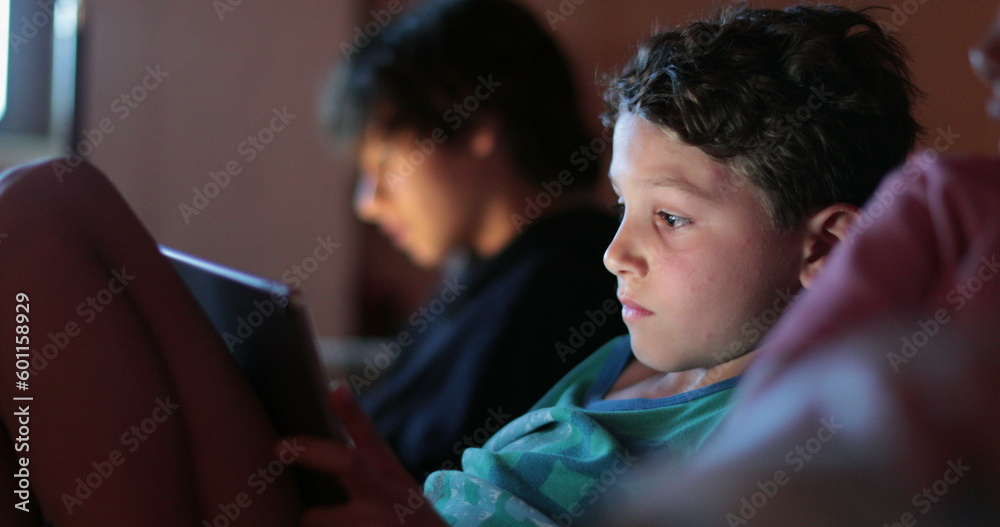 Kis watching movie on tablet device at night Kis watching movie on tablet device at night