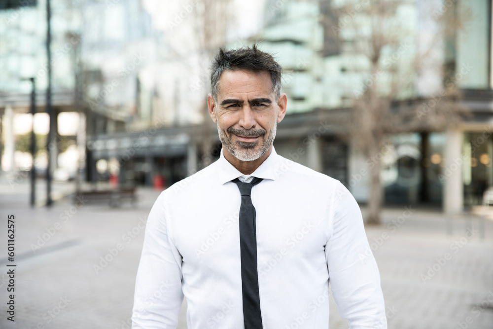 Portrait of a handsome mature CEO smiling with an urban background in a casual style. Attractive senior businessman looking at camera with a confident smile. Portrait of a handsome mature CEO smiling with an urban background in a casual style. Attractive senior businessman looking at camera with a confident smile.