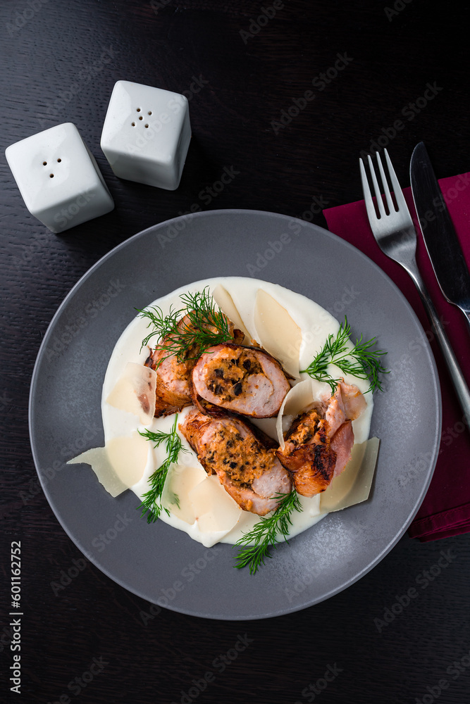 Meat rolls with cheese and mushrooms, creamy sauce, parmesan and herbs in plate. Meat rolls with cheese and mushrooms, creamy sauce, parmesan and herbs in plate.