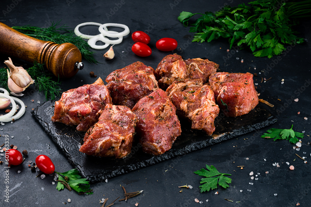 Portion beef for barbecue with onion, tomatoes, sauce and spices.
