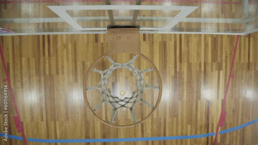 closeup of ball going through basketball hoop