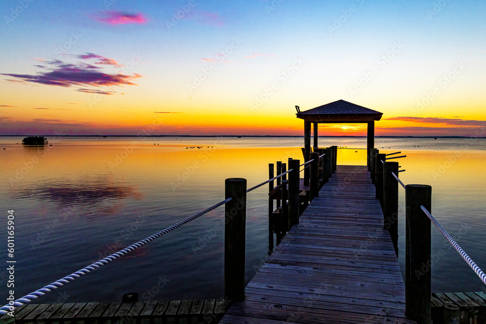 Sunset over a pier with water