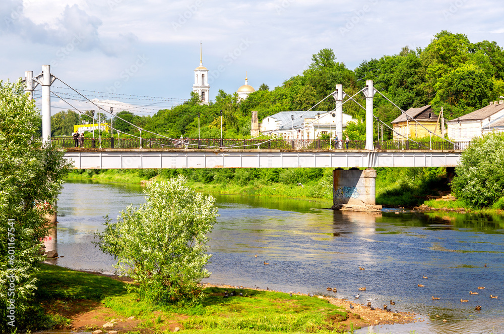 Pedestrian bridge across the Tvertsa river in summer day