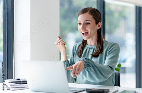 Excited business woman surprise looking on laptop having a good news..