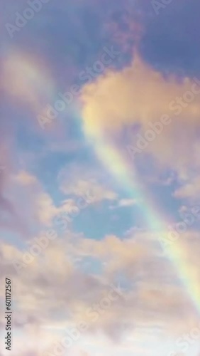Vertical video Rainbow in cloudy sky timelapse loop, seamless looping animated background motion backdrop sky and clouds, beautiful weather