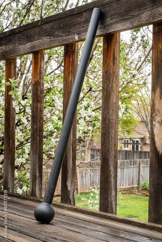 Fotografie steel mace (or macebell) on a wooden deck, fitness concept using unconventional