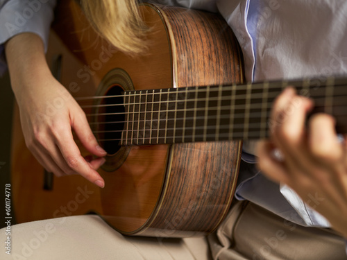 an unrecognizable person playing the classical guitar