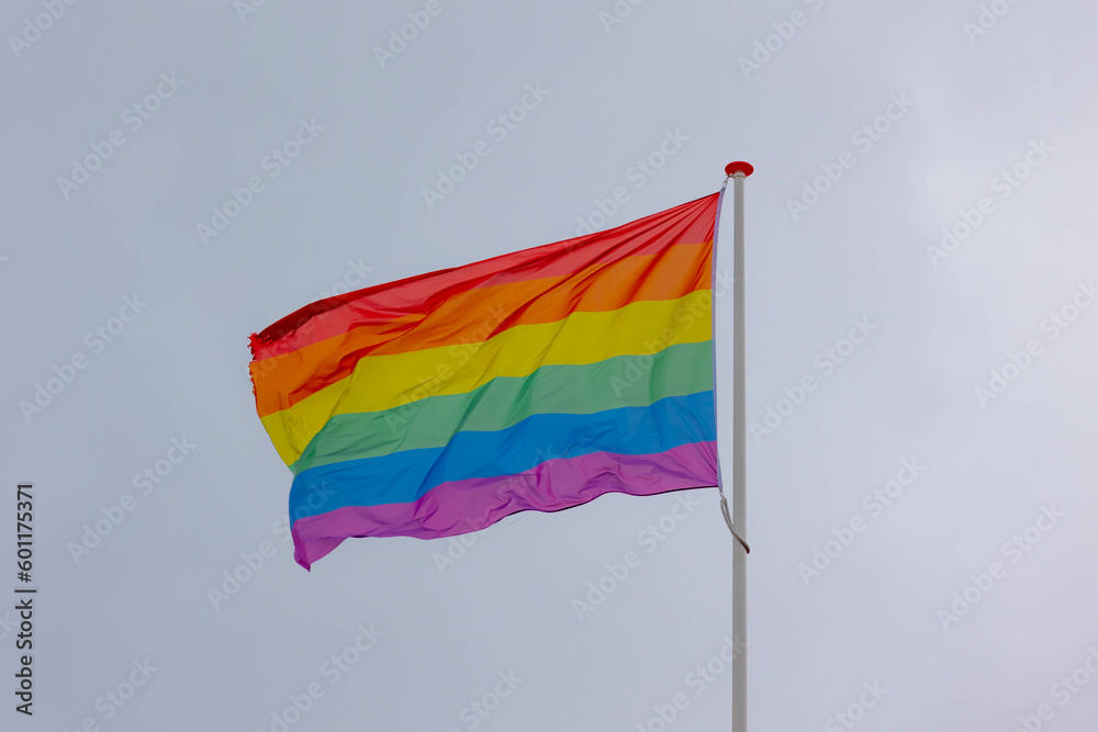 Celebration of pride month, Colourful rainbow flag hanging waving in the air with blue sky as background, Symbol of Gay, Lesbian, Bisexual and Transgender, LGBTQ community, Worldwide social movements. Celebration of pride month, Colourful rainbow flag hanging waving in the air with blue sky as background, Symbol of Gay, Lesbian, Bisexual and Transgender, LGBTQ community, Worldwide social movements.