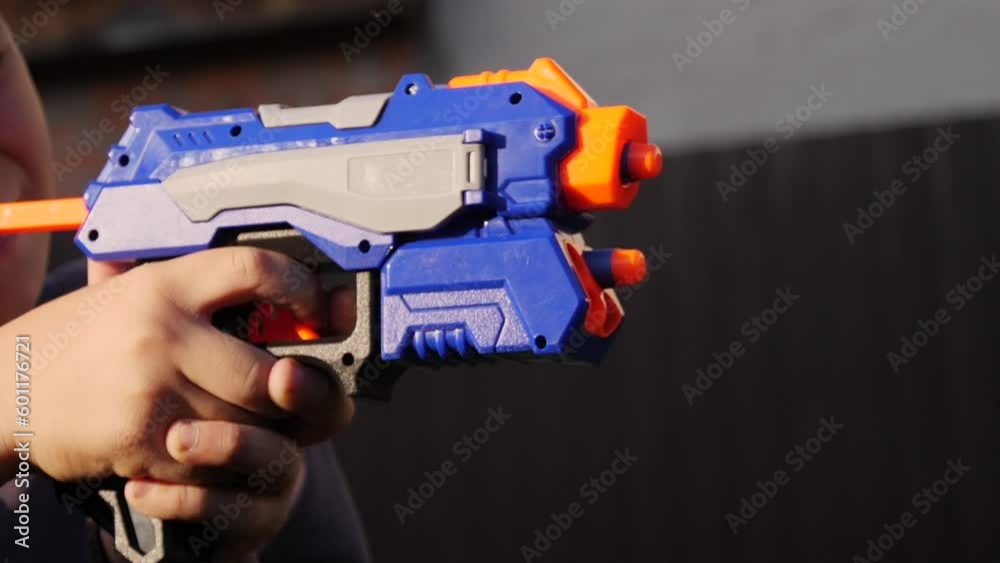 a little boy shoots a toy gun a little boy shoots a toy gun