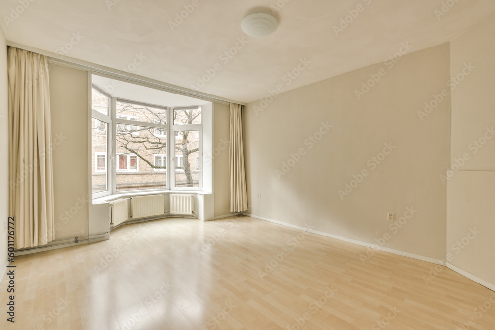 Fototapeta premium an empty living room with wood flooring and large windows looking out onto the street in front of the house