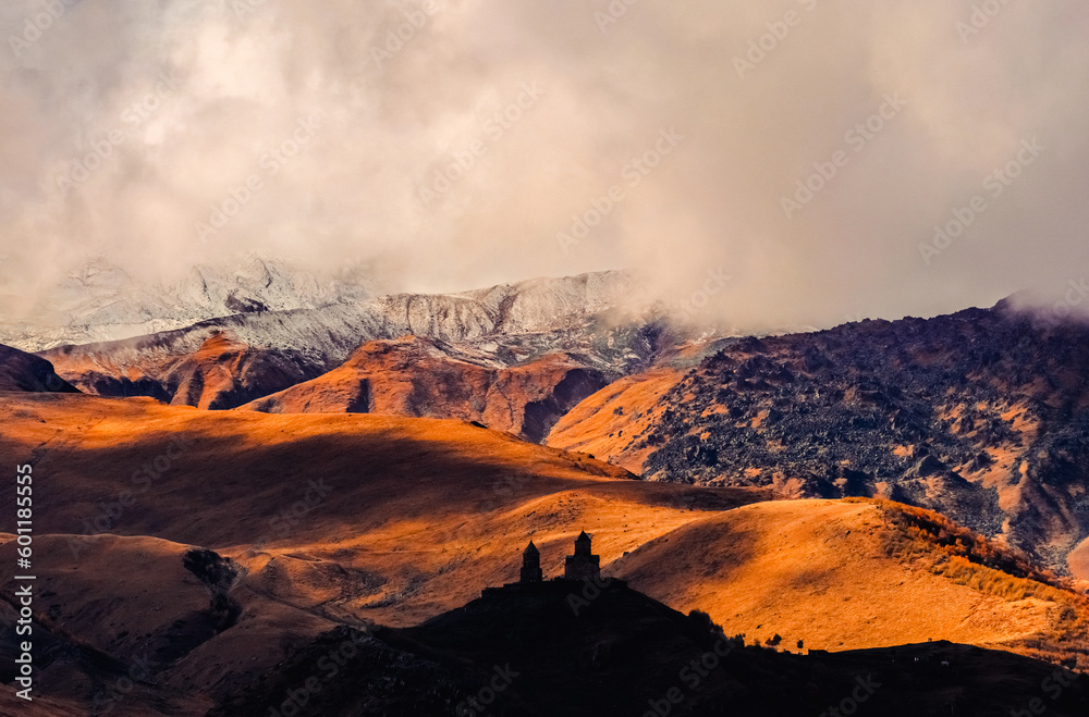 Naklejka premium Gergethi Trinity Church during sunset in Kazbegi, country of Georgia