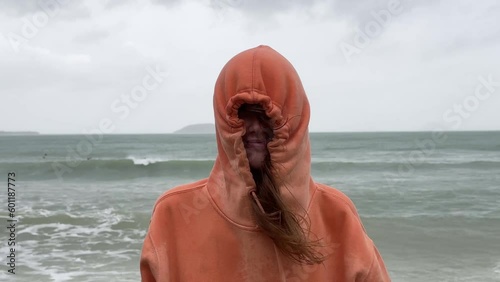 Portrait of unhappy depressed frozen trembling girl, young shivering from cold sad upset woman on the sea beach, bad weather on summer vacation 