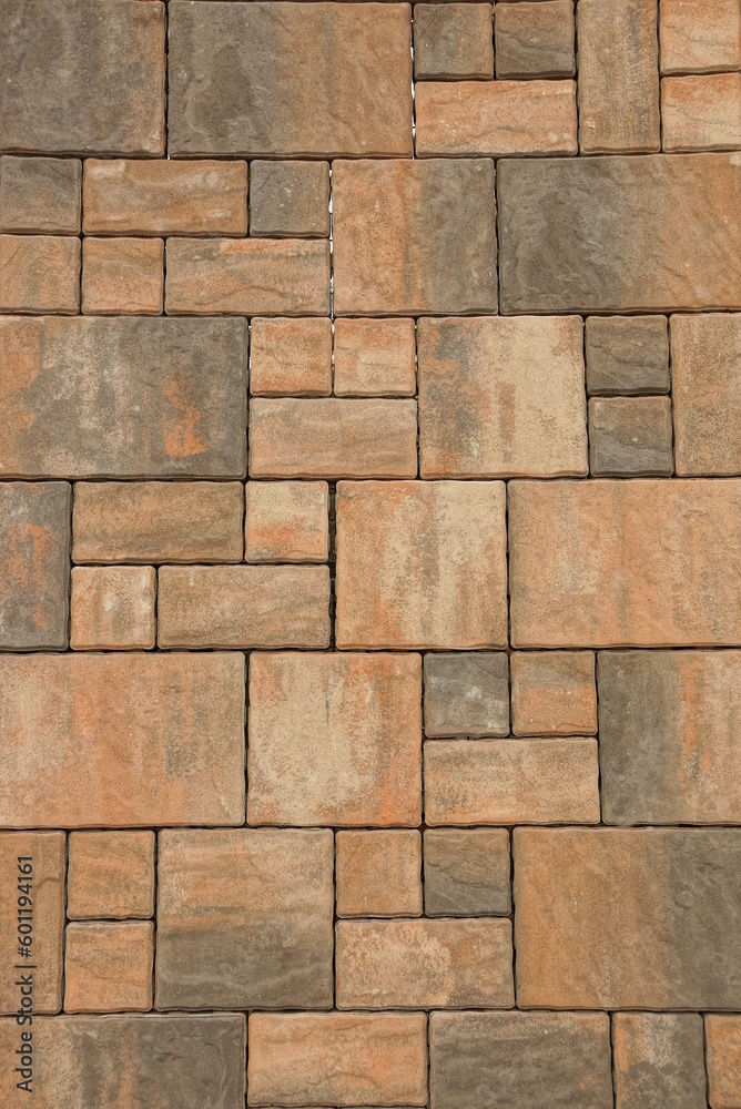 Texture of a fragment of gray brown paving slab on the road Texture of a fragment of gray brown paving slab on the road
