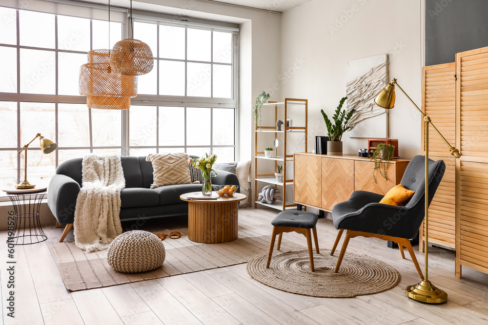 Fototapeta premium Interior of stylish living room with cozy sofa and coffee table near big window