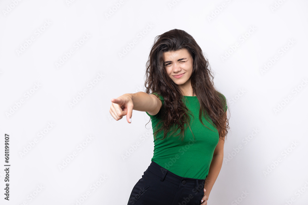 Happy young caucasian female in a shirt pointing fingers away Happy young caucasian female in a shirt pointing fingers away