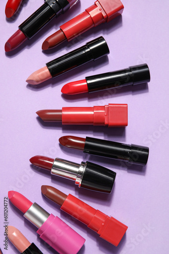 Different lipsticks on lilac background