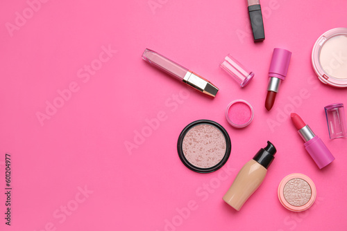Decorative cosmetics with lipsticks on pink background