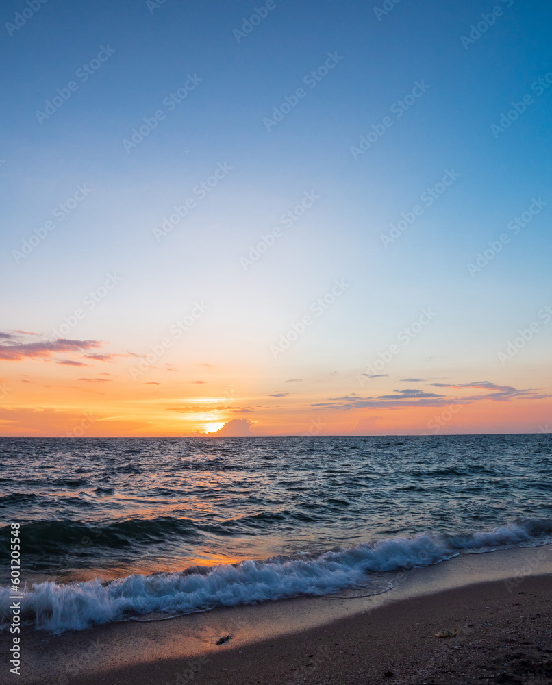Vertical front viewpoint landscape travel summer sea wind wave cool on holiday calm coastal big sun set sky light orange golden Nature tropical Beautiful evening hour day At Bang san Beach Thailand.