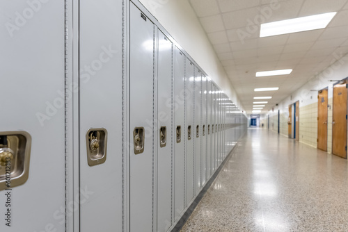 Empty middle school or high school hallway with gray student lockers 
