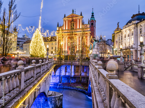 The Franciscan Church of the Annunciation and the three bridges bridge decorated with Christmas lights, Ljubljana, Slovenia