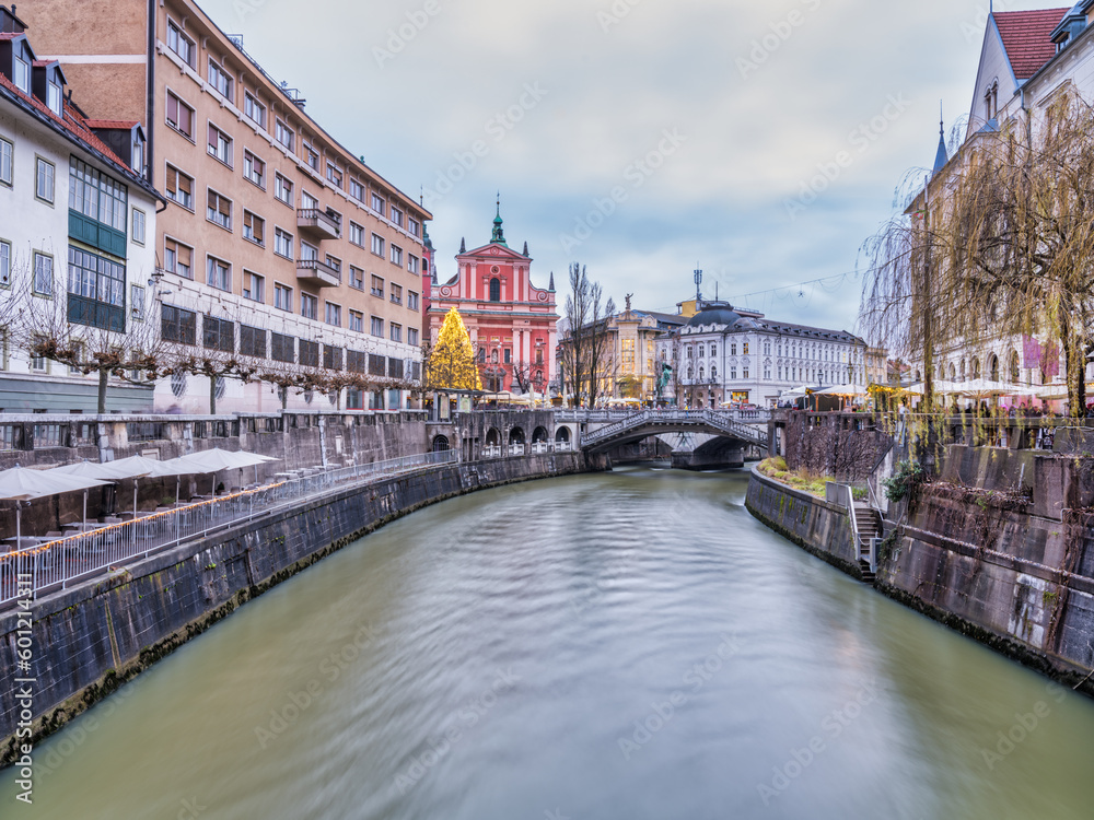 winding Ljubljana River, Franciscan Church and colorful buildings on either sides of the river, Slovenia