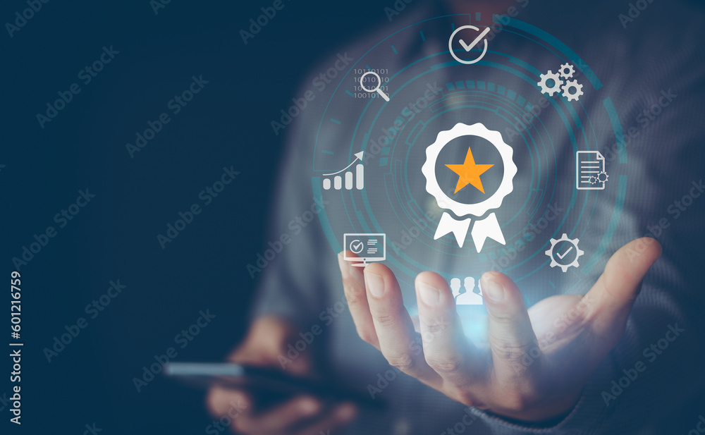 Fototapeta premium Standard quality assurance control certification business technology concept on virtual screen. Hand showing symbol quality assurance and standard, concept ISO certification of excellent service.