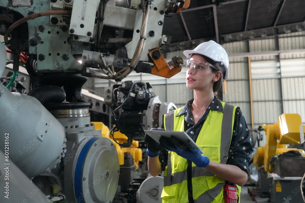 Mechanical engineers with robotic welder., Programming development technology work. Female industrial engineer working at automated AI robotic production factory.. Mechanical engineers with robotic welder., Programming development technology work. Female industrial engineer working at automated AI robotic production factory..