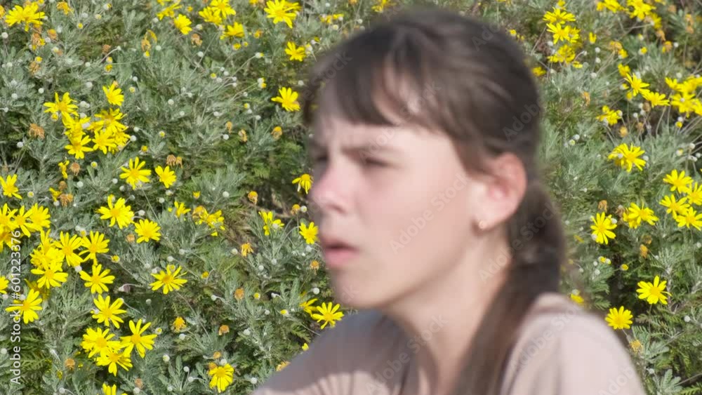 Spring asthma. A young girl with an asthma attack uses an inhaler. Use an inhaler during flowering. Spring asthma. A young girl with an asthma attack uses an inhaler. Use an inhaler during flowering.