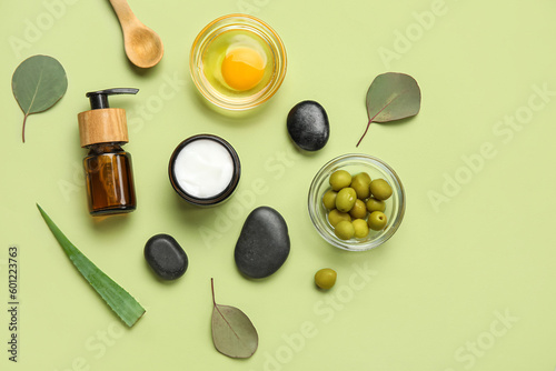 Composition with natural cosmetics, ingredients and spa stones on color background