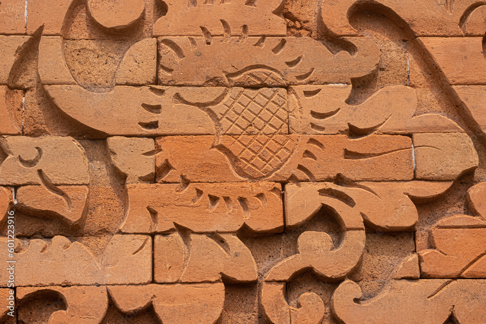 Brick wall with abstract design carving