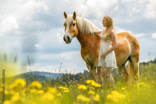 A young woman enjoying time with her haflinger horse in spring outdoors. Female equestrian friendship scene with her horse © Annabell Gsödl