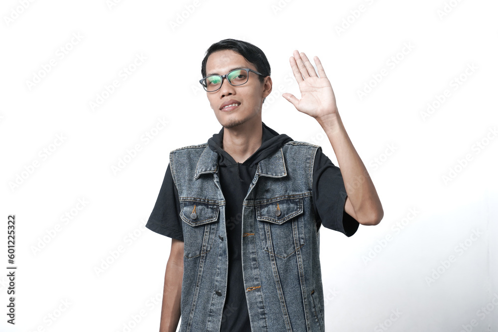 Asian man wearing sleeveless blue jean jacket, greeting clients with friendly smile. Isolated white background Asian man wearing sleeveless blue jean jacket, greeting clients with friendly smile. Isolated white background