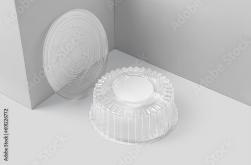 Blank plastic round packaging with transparent lid for baking, pastry and cakes isolated on white background. 3D illustration, 3D rendering.