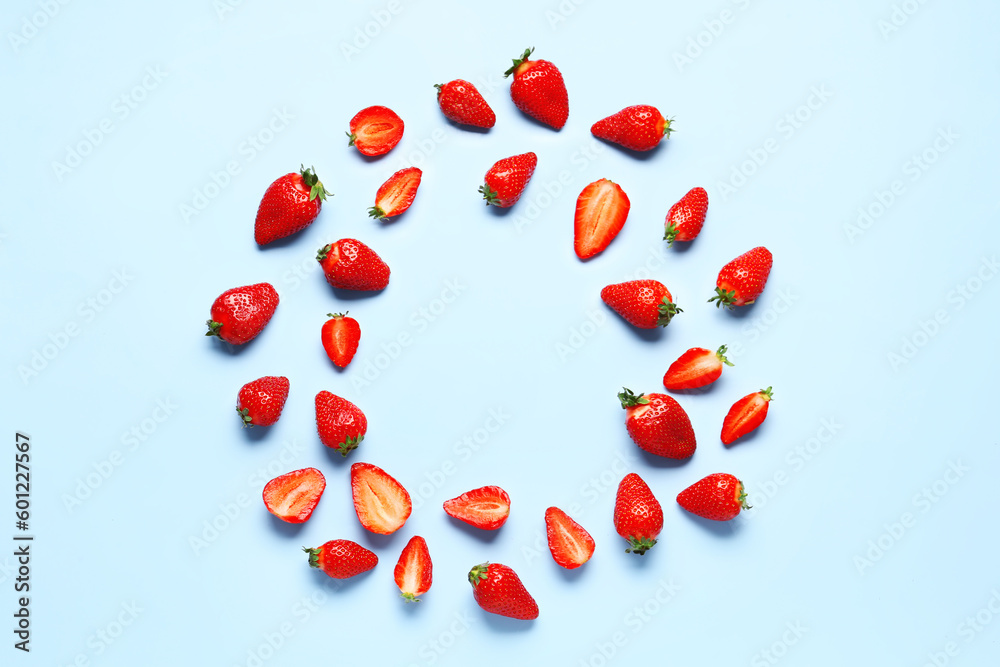 Frame made of fresh strawberries on blue background