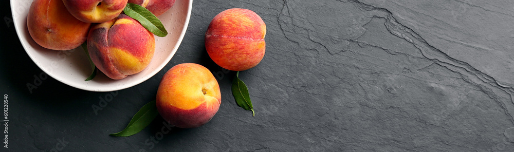 Fresh ripe peaches on black slate background, top view. Banner design with space for text Fresh ripe peaches on black slate background, top view. Banner design with space for text