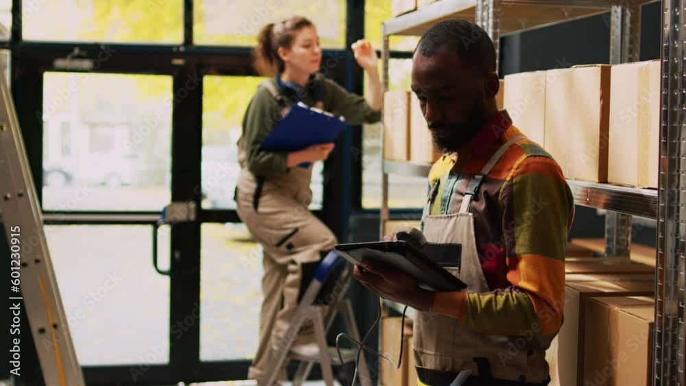 Young person scanning barcodes in depot, working on quality control with supply chain in storage room. Male depot worker checking stock of products, manufacturing goods at job. Young person scanning barcodes in depot, working on quality control with supply chain in storage room. Male depot worker checking stock of products, manufacturing goods at job.