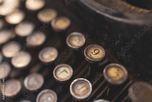 Vintage typewriter with Cyrillic alphabet characters keyboard, writing a text letter on empty page sheet of craft paper, old-fashioned writer machine, view of hands writing book and printing letters