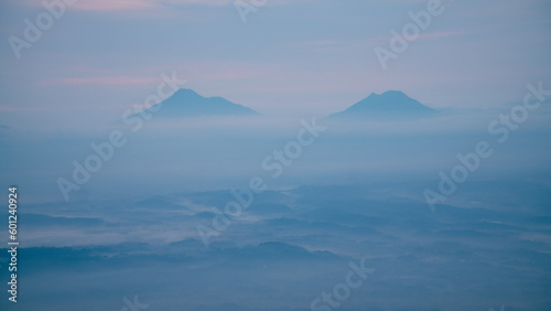 Two mountain in the morning in foggy condition weather