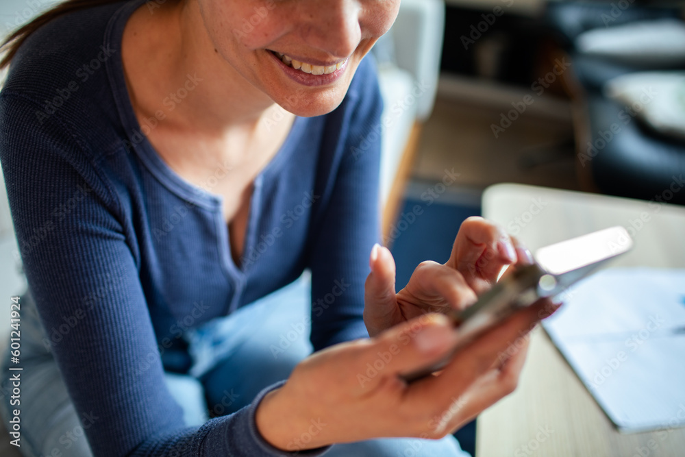 Young woman using a smart phone at home