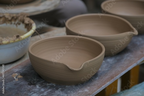 The process of making tableware product from clay. Pembuatan mangkok dan gelas dari tanah liat photo
