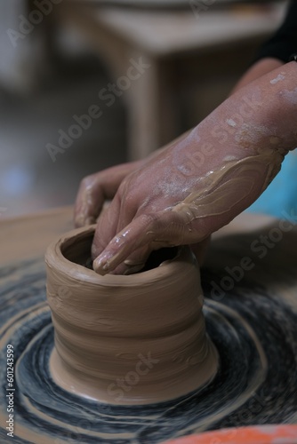 he process of making tableware product from clay. Craftman work at workshop. Pembuatan mangkok dan gelas dari tanah liat photo