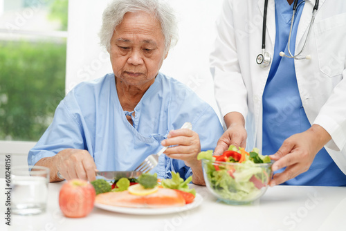 Asian Nutritionist holding healthy food for patient in hospital, nutrition and vitamin.