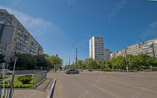 Yuzhny city in Odessa region: summer day, road and high-rise buildings