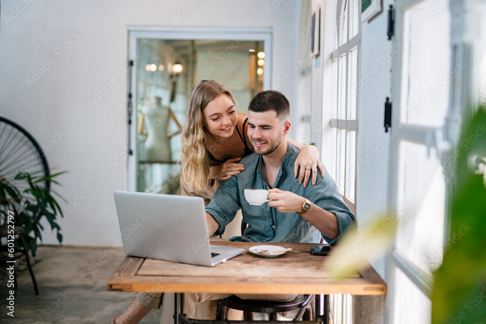 Happy young couple married spouse web surfing, making purchases online or booking flight tickets. The concept of couples sharing one idea together. Happy young couple married spouse web surfing, making purchases online or booking flight tickets. The concept of couples sharing one idea together.
