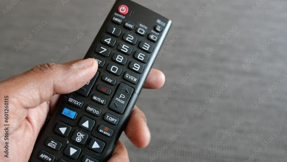 close up of man hand holding tv remote. close up of man hand holding tv remote.