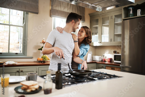 Love, food and cooking with couple in kitchen and hugging for breakfast, morning and happiness. Smile, care and nutrition with man and woman eating at home for happy, health and hungry together