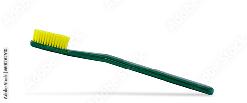 Photo of a green toothbrush isolated on a white background.