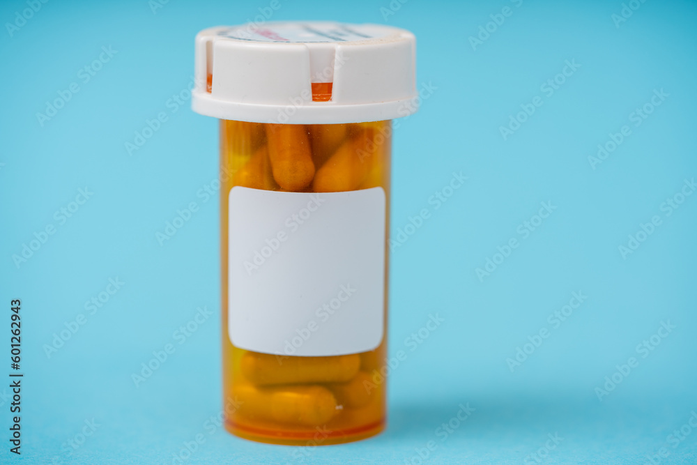 Amber prescription packaging for pills on a blue background Amber prescription packaging for pills on a blue background