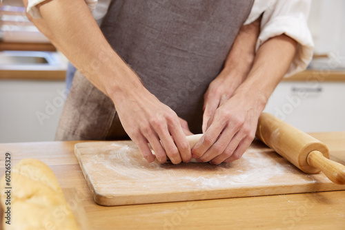 close up gay couple hands making a bread together in the kitchen © offsuperphoto