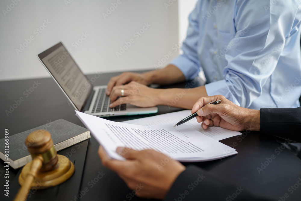 Legal counsel presents to the client a signed contract with gavel and legal law. justice and lawyer concept Legal counsel presents to the client a signed contract with gavel and legal law. justice and lawyer concept